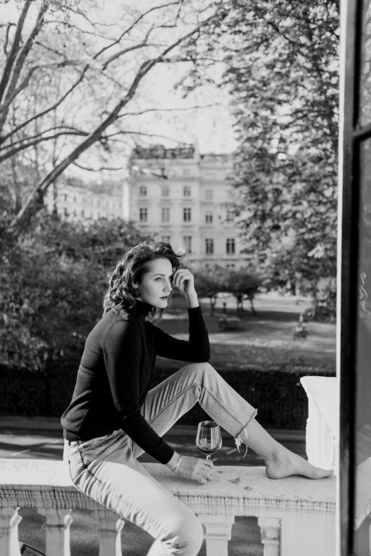 a black and white photo of a woman sitting on a balcony, a black and white photo, by Peter Basch, rachel weisz, in a square, clothed!! lucien levy - dhurmer, ffffound