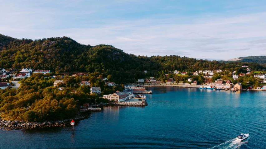 a small boat in the middle of a large body of water, by Jesper Knudsen, pexels contest winner, renaissance, cottage town, maple syrup sea, hills and ocean, late summer evening