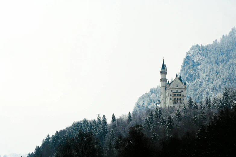 a castle sitting on top of a snow covered mountain, unsplash contest winner, german romanticism, grey forest in the background, white building, festivals, thumbnail