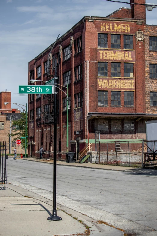 a street sign sitting on the side of a road, by Washington Allston, temporary art, in a massive cavernous iron city, nostalgic 8k, rundown buildings, where a large