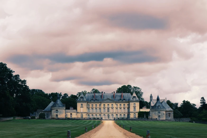 a large castle sitting on top of a lush green field, an album cover, inspired by Pierre Pellegrini, unsplash contest winner, baroque, pink and grey clouds, moody : : wes anderson, versailles, pastel hues