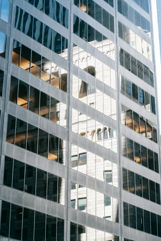 a tall building with a clock on the side of it, inspired by Ned M. Seidler, pexels contest winner, reflective windows, square lines, window ( city ), 1 4 9 3