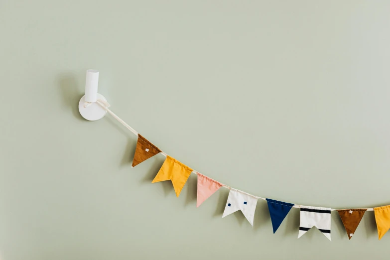 a close up of a string of pennants on a wall, inspired by The Family Circus, unsplash, rgb wall light, product view, white, velvet