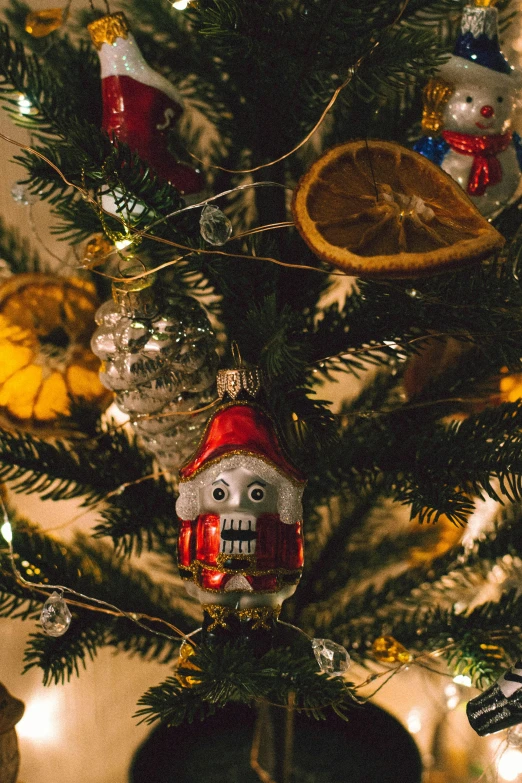 a close up of a christmas tree with ornaments, a portrait, pexels, folk art, creepy carved expression, thumbnail, 8k 50mm iso 10, instagram photo