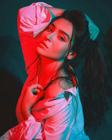 a woman with long hair posing for a picture, a colorized photo, inspired by Elsa Bleda, trending on pexels, red neon details, madison beer girl portrait, androgynous person, high-contrast lighting