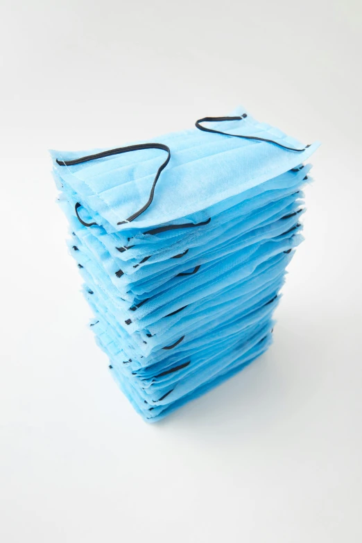 a stack of surgical masks on a white background, by Paul Davis, reddit, 256x256, sky blue, 4k/8, wide - shot