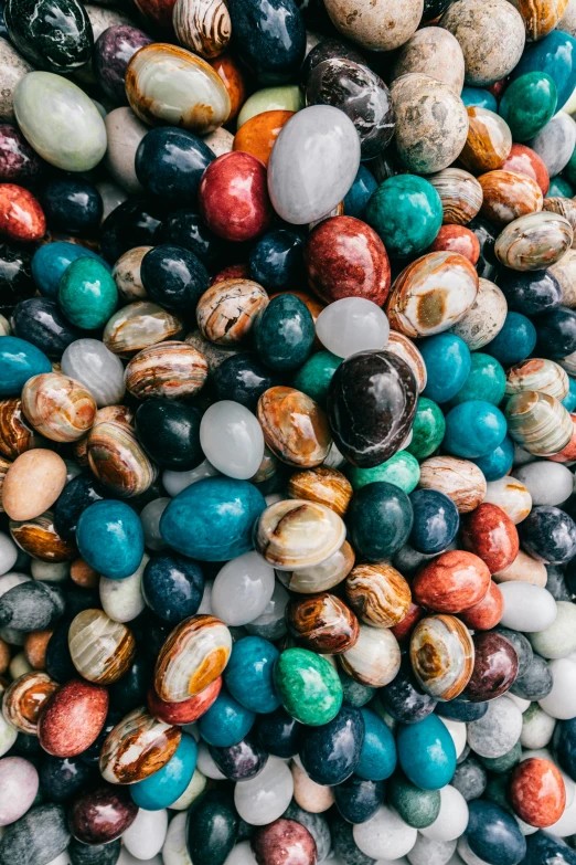 a pile of multicolored beans sitting on top of each other, an album cover, by Jessie Algie, trending on unsplash, maximalism, ornate egg, geology, madagascar, universe