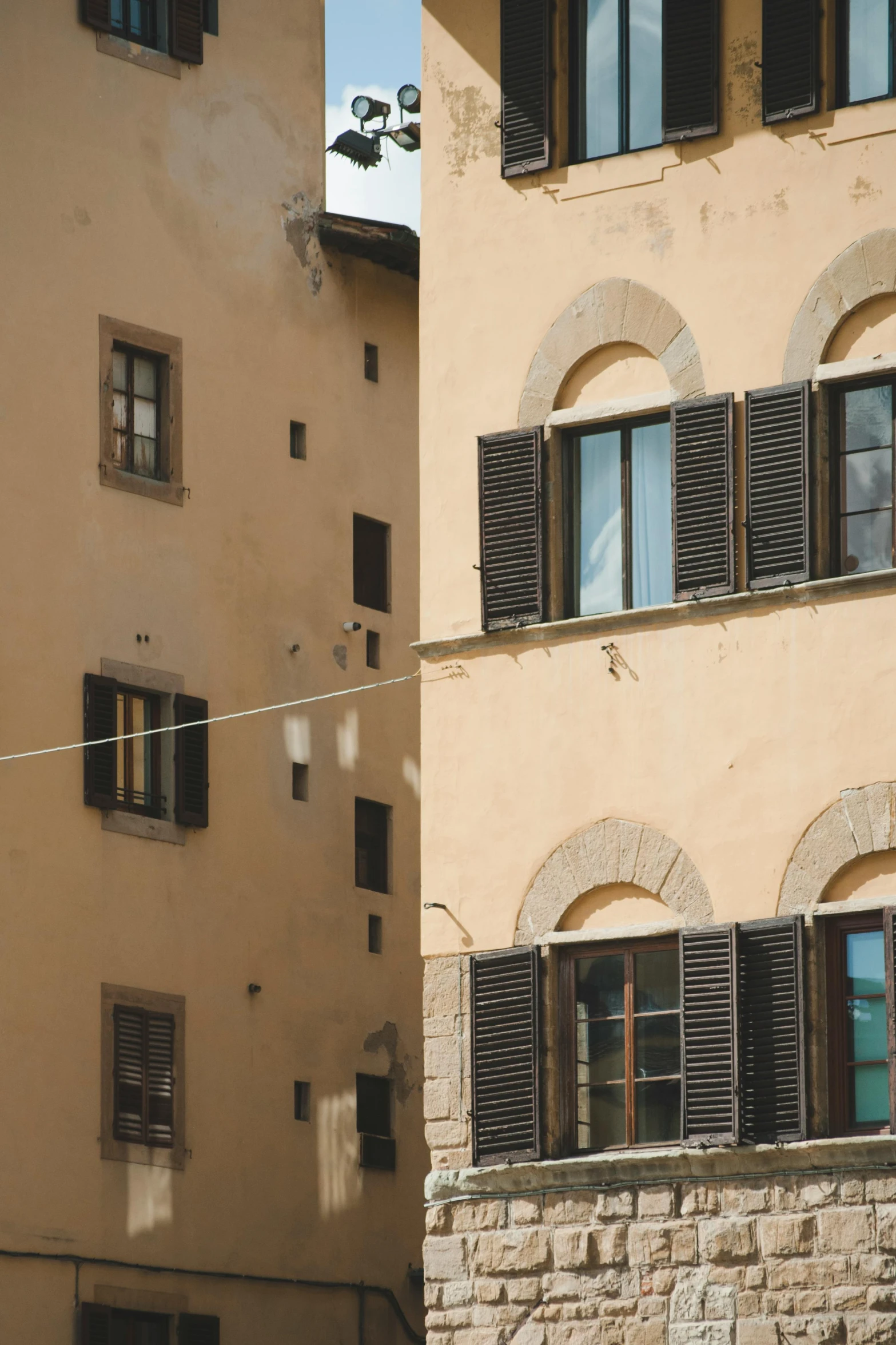 a couple of buildings that are next to each other, inspired by Niccolò dell' Abbate, trending on pexels, renaissance, black windows, afternoon light, square, raw sienna