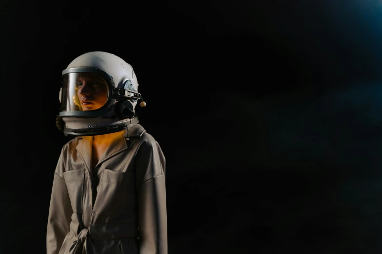 a close up of a person wearing a helmet, light and space, girl wearing uniform, floating in empty space, standing with a black background, promo image