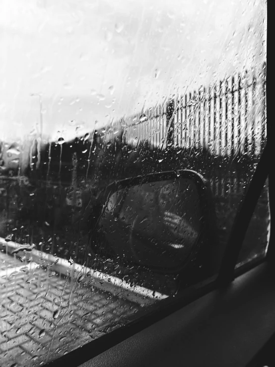 a black and white photo of a car in the rain, by Lucia Peka, train window, shot on iphone 6, window ( city ), untitled