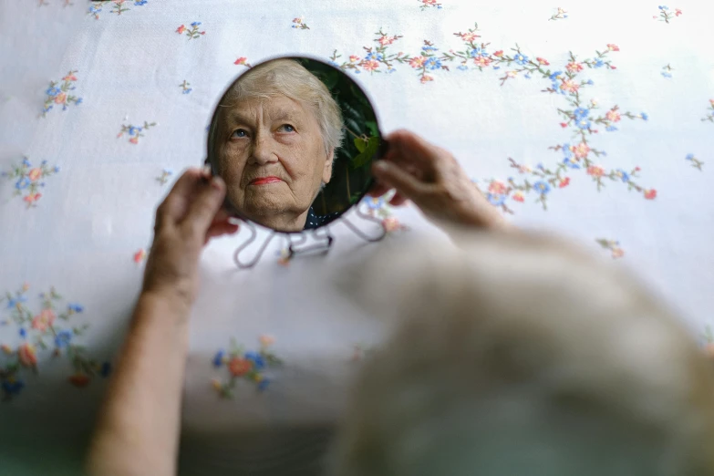 a woman looking at her reflection in a mirror, inspired by Anna Füssli, pexels contest winner, hyperrealism, elderly, birdseye view, 2022 photograph, documentary still