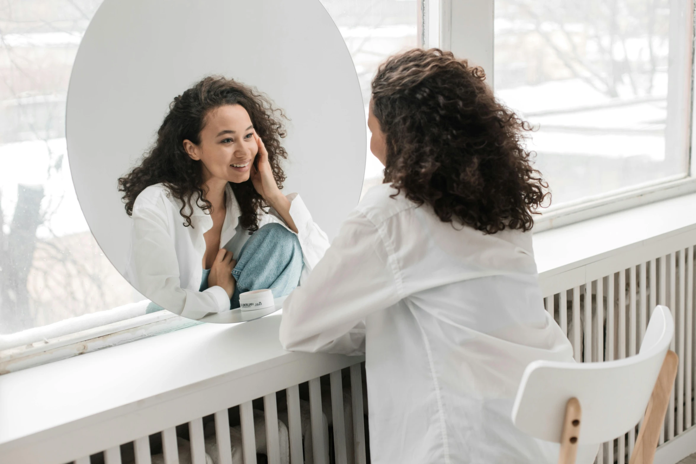 a woman sitting at a table in front of a mirror, pleasing aesthetics, doctors mirror, turning her head and smiling, uploaded