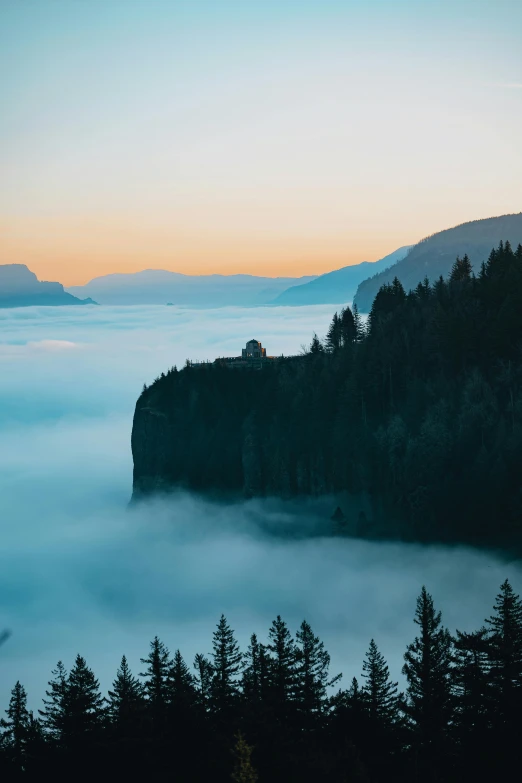 a large body of water surrounded by trees, by Johannes Voss, pexels contest winner, romanticism, above low layered clouds, cliff side at dusk, today\'s featured photograph 4k, valley mist