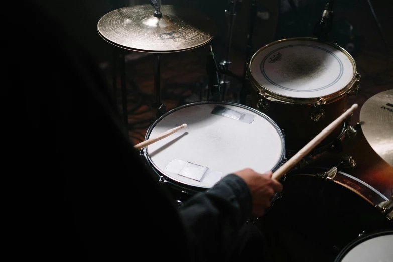 a close up of a person playing drums, an album cover, unsplash, rectangle, tungsten, digital artwork, handcrafted