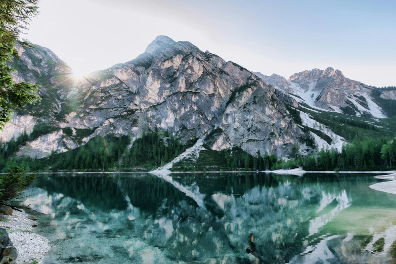 a lake with a mountain in the background, pexels contest winner, glossy surface, multiple stories, confident looking, crystal clear