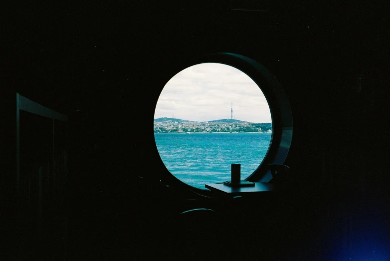 a round window with a view of a body of water, a polaroid photo, pexels contest winner, hurufiyya, ship interior, istanbul, soft vinyl, sydney hanson