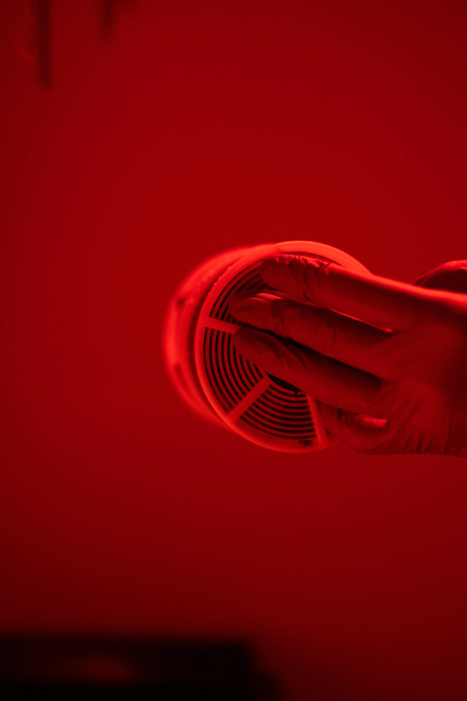 a person holding a fan in their hand, by Adam Chmielowski, pexels contest winner, symbolism, volumetric lighting. red, hibernation capsule close-up, hairdryer, abstract claymation