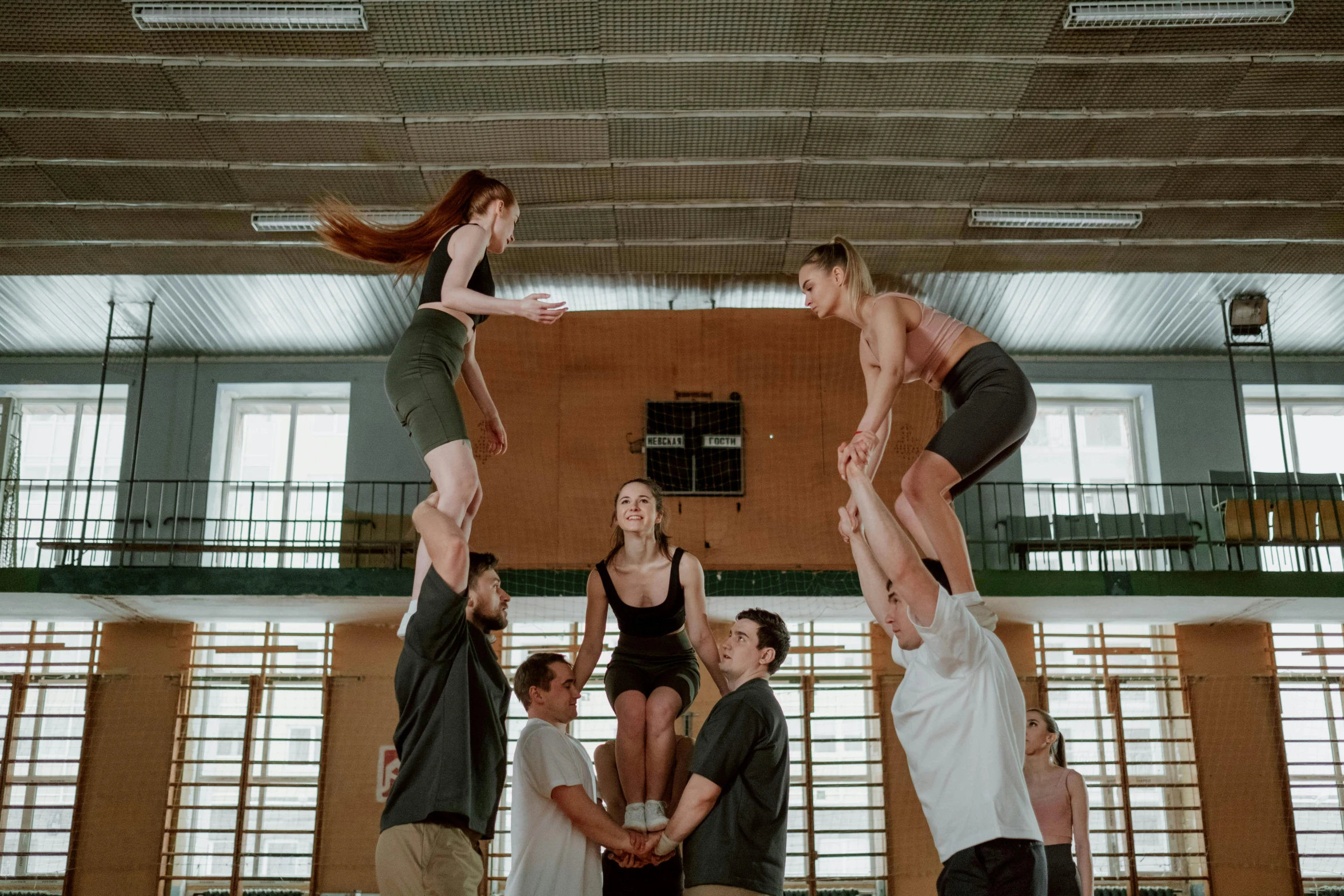 a group of people standing on top of each other, by Nina Hamnett, pexels contest winner, academic art, in a gym, production photo, hasbulla magomedov, high high high quality