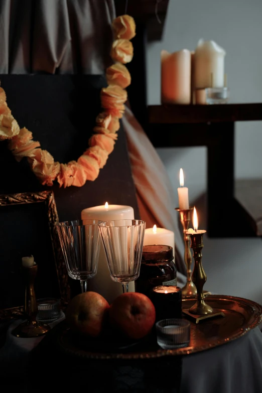 a bunch of candles sitting on top of a table, a still life, inspired by Georges de La Tour, renaissance, medium close shot, harvest, harmony black room, snacks