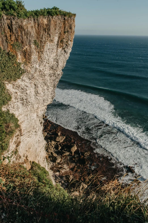 a man standing on top of a cliff next to the ocean, les nabis, normandy, head straight down, slide show, 8k octan photo