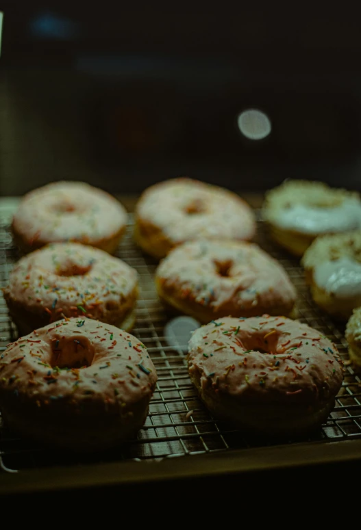 a bunch of doughnuts that are on a rack, by Niko Henrichon, trending on unsplash, renaissance, 15081959 21121991 01012000 4k