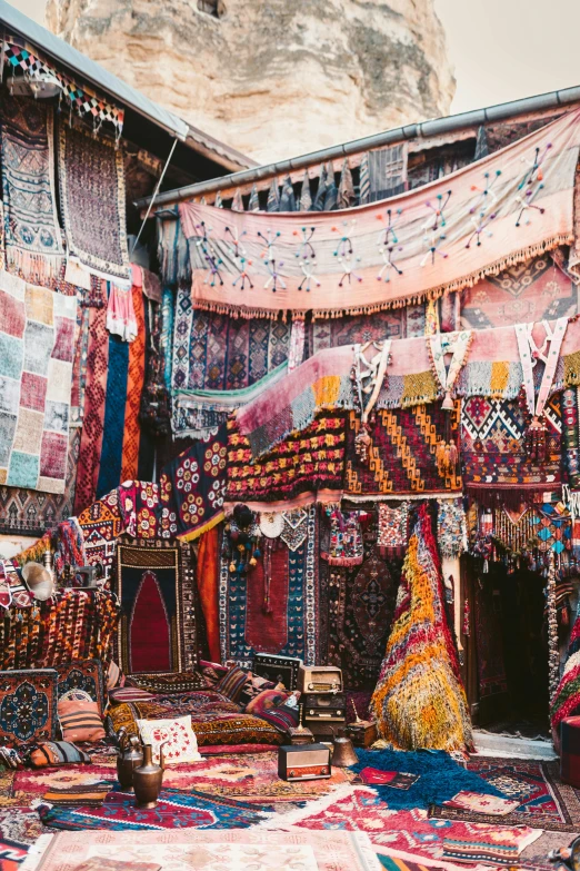 a room filled with lots of colorful rugs, a colorized photo, inspired by Alberto Morrocco, trending on unsplash, street vendors, canopies, village, photograph taken in 1989