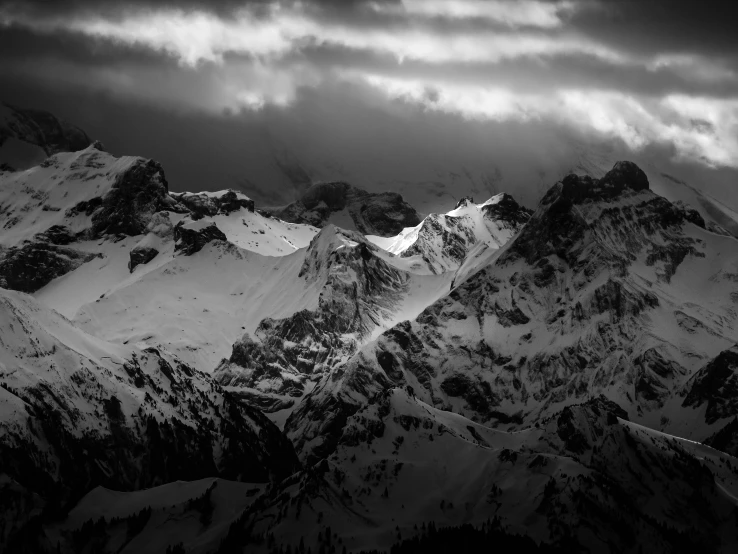 a black and white photo of snow covered mountains, a black and white photo, by Cedric Peyravernay, pexels contest winner, baroque, dramatic lightin, dramatic light 8 k, dramatic”
