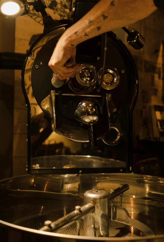 a person using a coffee grinder in a kitchen, by Matthias Stom, process art, melbourne, 1 9 2 0's style speakeasy, low lighting, cappuccino