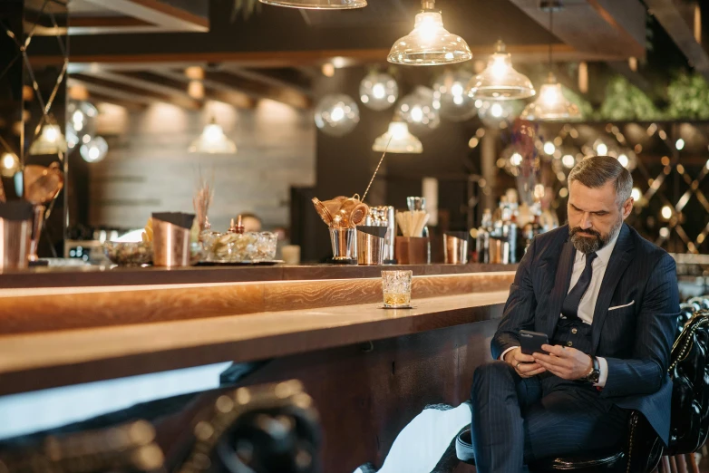 a man sitting at a bar looking at his cell phone, trending on pexels, renaissance, costumes from peaky blinders, 40 years old women, avatar image, 15081959 21121991 01012000 4k