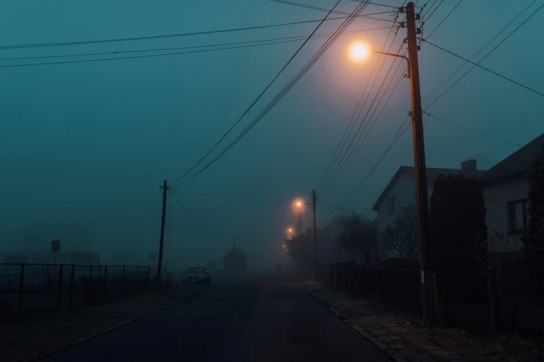 a street light sitting on the side of a road, an album cover, inspired by Elsa Bleda, unsplash contest winner, ultra dense fog, magical soviet town, cyan fog, dark neighborhood