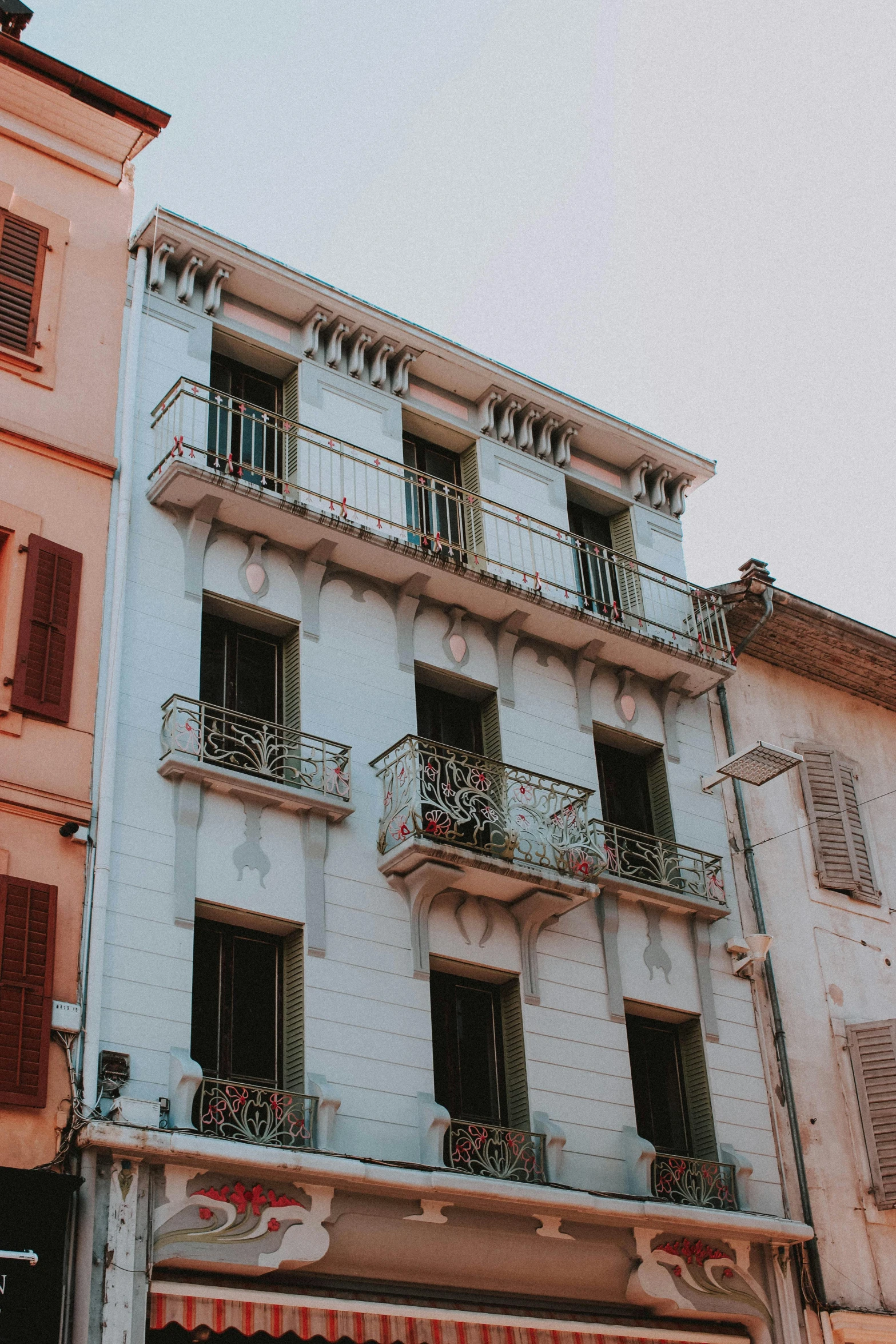 a couple of buildings that are next to each other, pexels contest winner, art nouveau, cannes, old house, balcony, low quality photograph