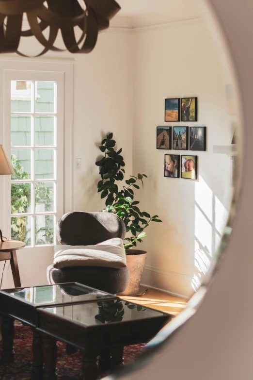 a living room filled with furniture and a round mirror, poster art, by Niko Henrichon, unsplash contest winner, light and space, french door window, bay area, profile image, soft light from the side