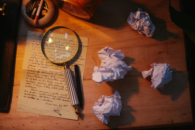 a wooden table topped with lots of paper and a magnifying glass, writing a letter, hyperrealistic lighting, promo image, sad scene