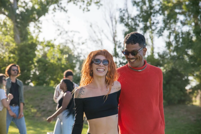 a man and a woman standing next to each other, an album cover, pexels, outdoor rave, redhead woman, 2 1 savage, picnic