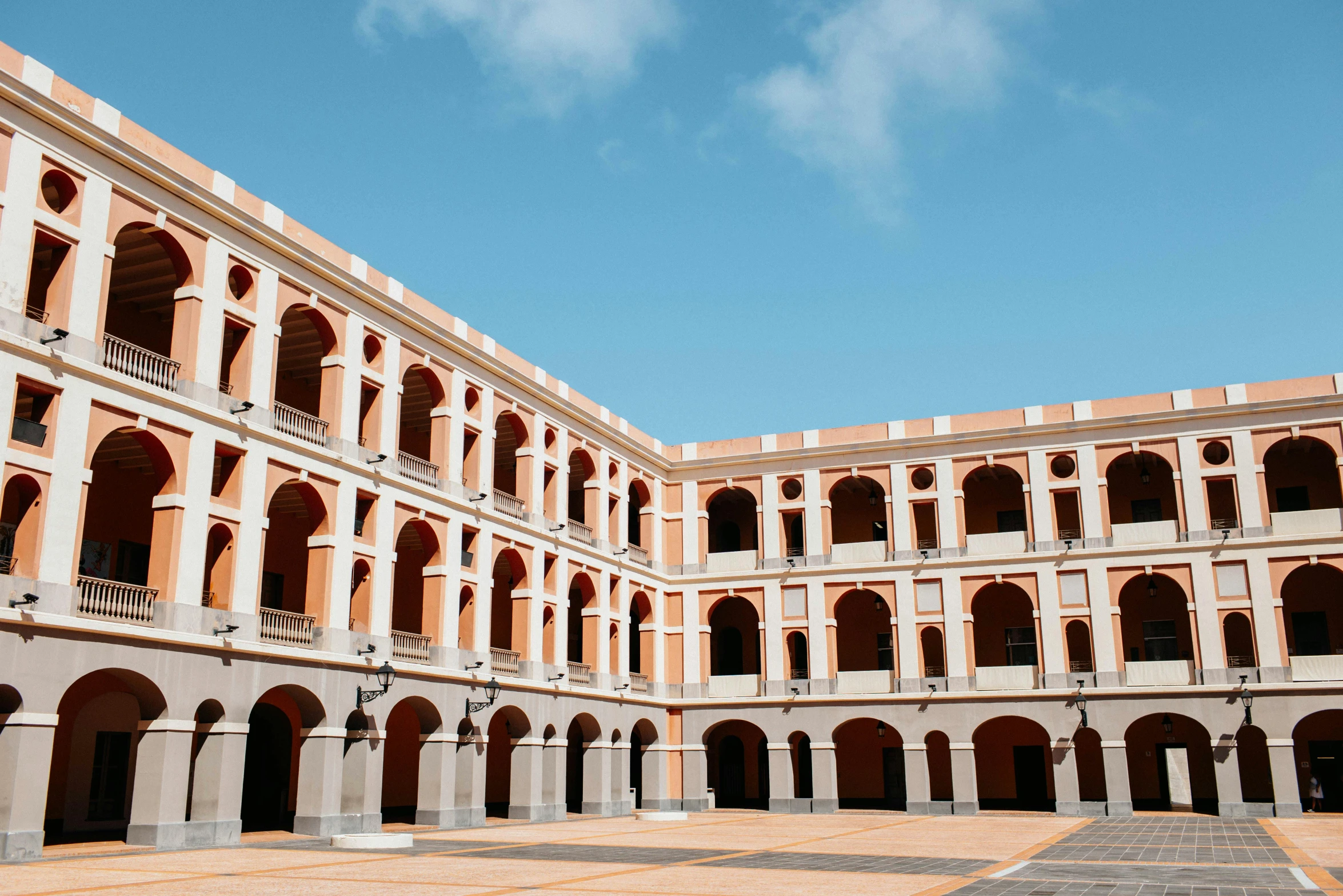 the courtyard of a building with arches and arches, inspired by Luis Paret y Alcazar, pexels contest winner, quito school, clemens ascher, palace background, brown, where a large