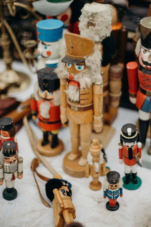 a group of nutcrackers sitting on top of a table, various items, zoomed in, army, vintage aesthetic