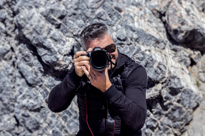 a man taking a picture with a camera, by Peter Churcher, rugged face, avatar image, telephoto, full - frame