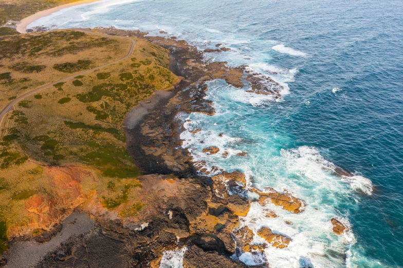 a large body of water next to a beach, by Lee Loughridge, pexels contest winner, happening, coastal cliffs, birdseye view, bulli, highly detailded