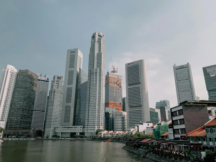 a large body of water surrounded by tall buildings, by Patrick Ching, pexels contest winner, hyperrealism, lee kuan yew, the photo was taken from a boat, hd footage, fan favorite