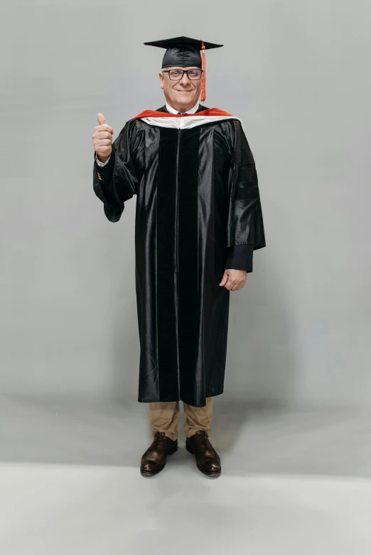 a man in a graduation gown giving a thumbs up, by Ben Zoeller, tall entry, official product photo, 8ft tall, inauguration