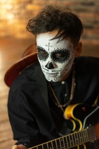 a man with a face paint playing a guitar, momento mori, profile image, promo image, portrait image