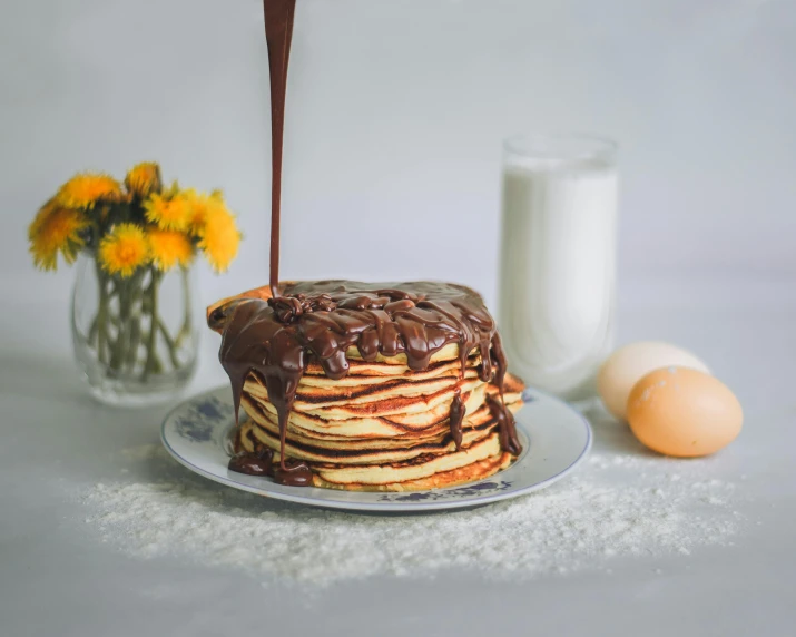 a stack of pancakes sitting on top of a plate, pexels contest winner, romanticism, smothered in melted chocolate, gif, silo, flowers around