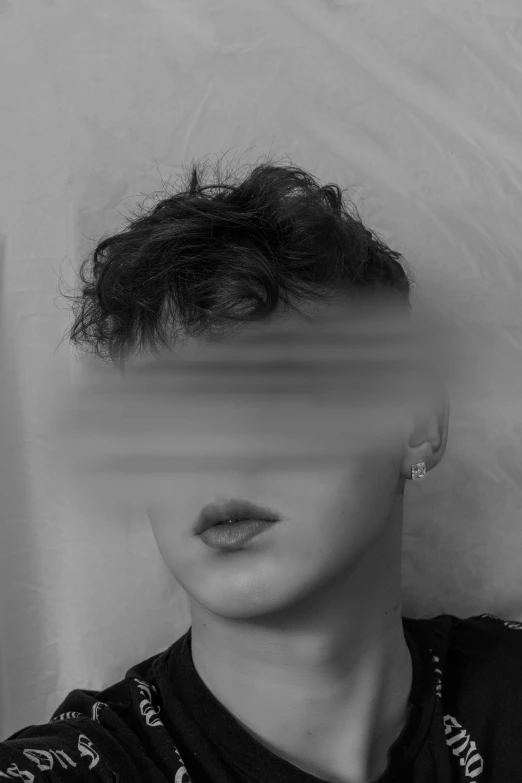 a black and white photo of a woman's face, inspired by Jean Malouel, tumblr, censored, non binary model, hiding, curly