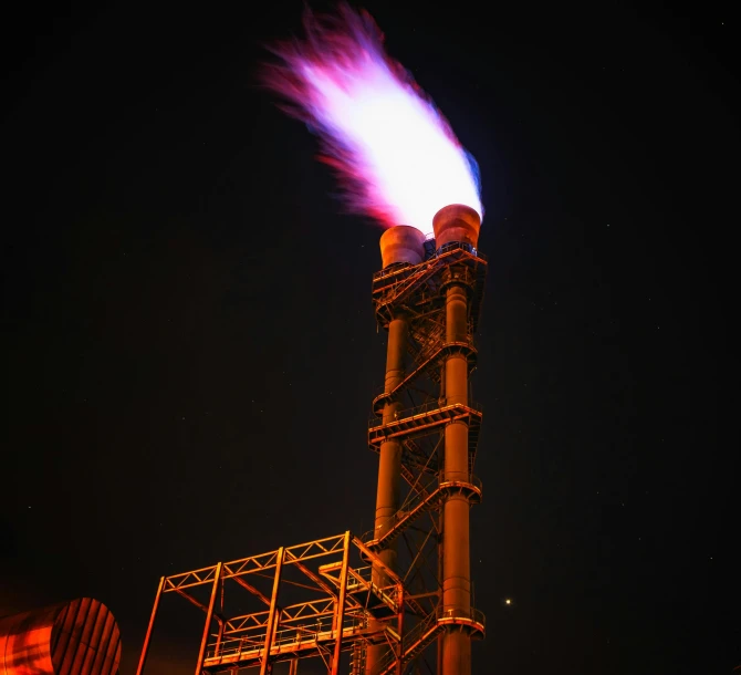 a factory with a lot of smoke coming out of it, an album cover, by Jan Rustem, hurufiyya, nighttime photography, petrol energy, low purple flame, shot on sony a 7