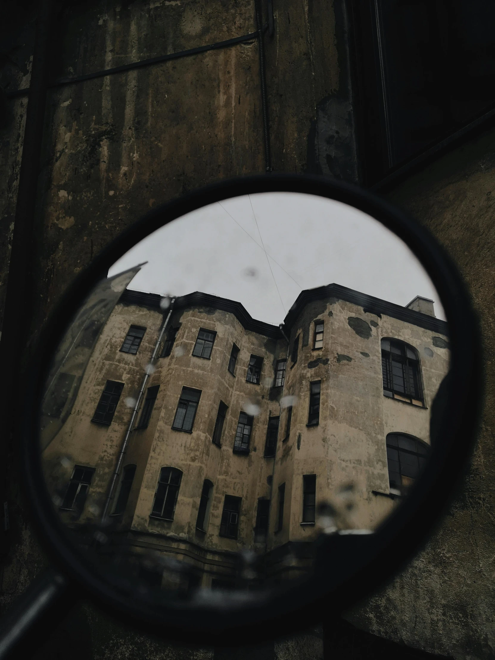 a reflection of a building in a mirror, a picture, pexels contest winner, dark dirty grungy streets, ((fish eye)), vintage aesthetic, overcast day