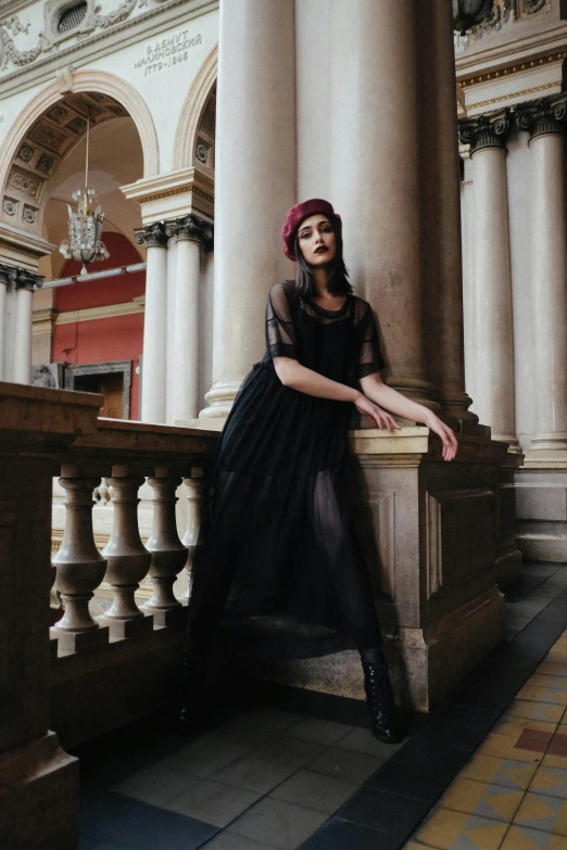 a woman in a black dress sitting on a balcony, pexels contest winner, renaissance, black beret, in a large hall, gothic!!, pose 4 of 1 6