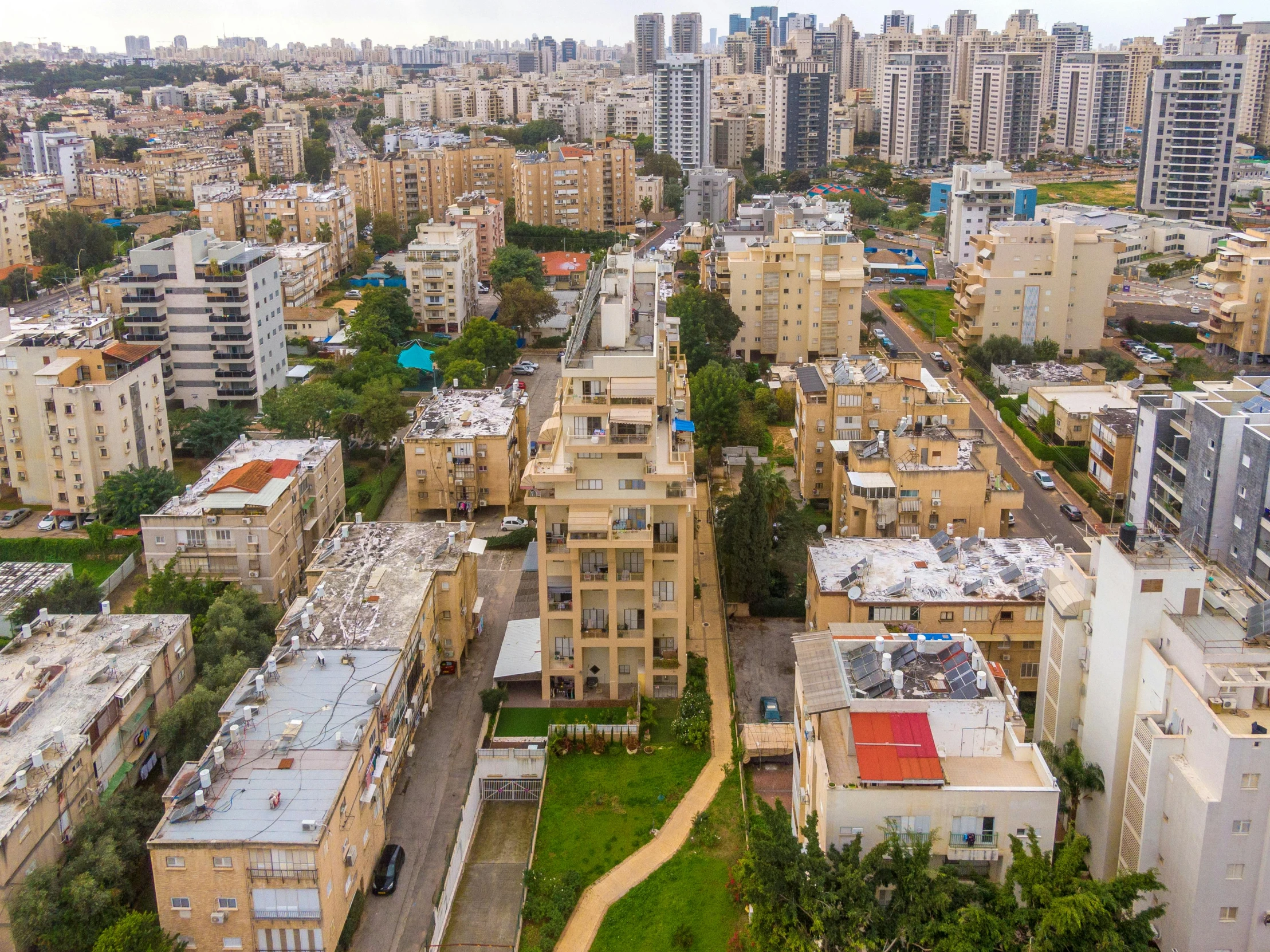 a city filled with lots of tall buildings, by Steven Belledin, pexels contest winner, israel, drone wide shot, residential area, view(full body + zoomed out)