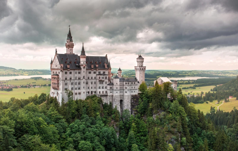 a castle sitting on top of a lush green hillside, unsplash contest winner, renaissance, munich, gray, brown, foam