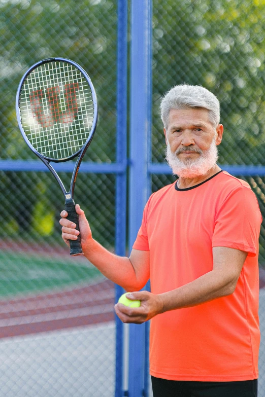 a man holding a tennis racket and a tennis ball, gray hair and beard, upper body image, 5 5 yo, feature