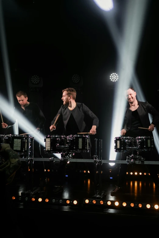 a group of men standing on top of a stage, an album cover, by Julia Pishtar, shutterstock, drum pads, nordic, 15081959 21121991 01012000 4k, deep black